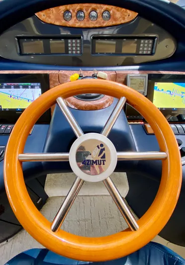 Last Minute Yacht Photos Pics Steering wheel of a 2002 Azimut 55 yacht with navigation displays.