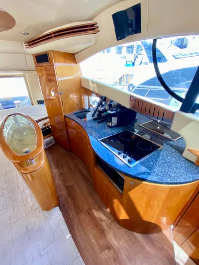 Last Minute Yacht Photos Pics Luxurious 2002 Azimut 55 yacht kitchen with modern appliances and sleek wood finishes.