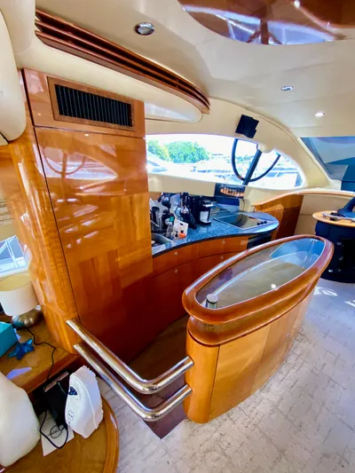 Last Minute Yacht Photos Pics Luxurious interior of a 2002 Azimut 55 yacht with polished wood finishes.