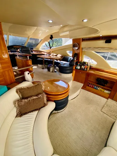 Last Minute Yacht Photos Pics Luxurious interior of a 2002 Azimut 55 yacht with elegant seating and modern amenities.