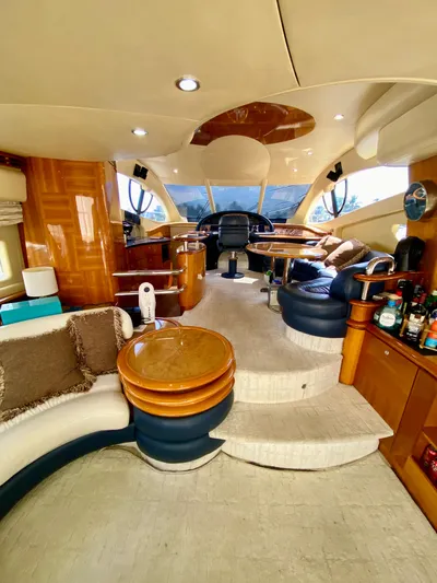 Last Minute Yacht Photos Pics Luxurious interior of a 2002 Azimut 55 yacht with elegant seating and helm.