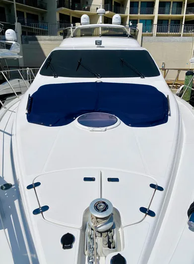 Last Minute Yacht Photos Pics 2002 Azimut 55 yacht with sleek design and blue sunshade.