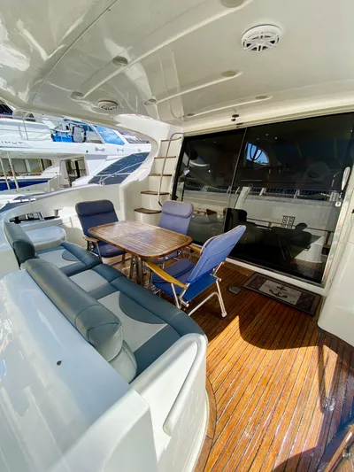 Last Minute Yacht Photos Pics Luxurious 2002 Azimut 55 yacht interior with seating and wooden deck.