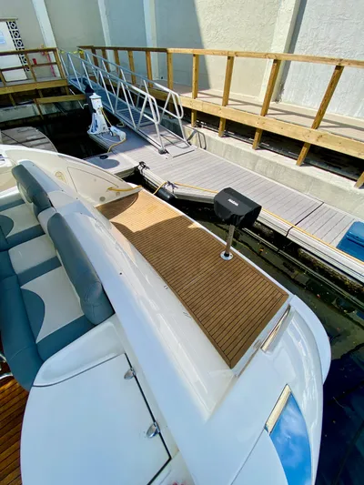 Last Minute Yacht Photos Pics 2002 Azimut 55 yacht docked, featuring sleek design and spacious deck.