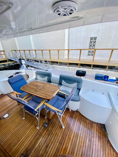 Last Minute Yacht Photos Pics 2002 Azimut 55 yacht deck with seating and wooden table.