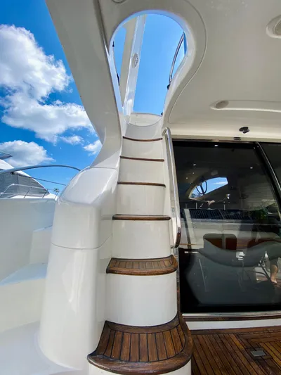 Last Minute Yacht Photos Pics Staircase on 2002 Azimut 55 yacht with wooden steps and sleek design.