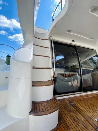 Last Minute Yacht Photos Pics Azimut 55 yacht 2002 model, featuring elegant wooden stairs and sleek design.