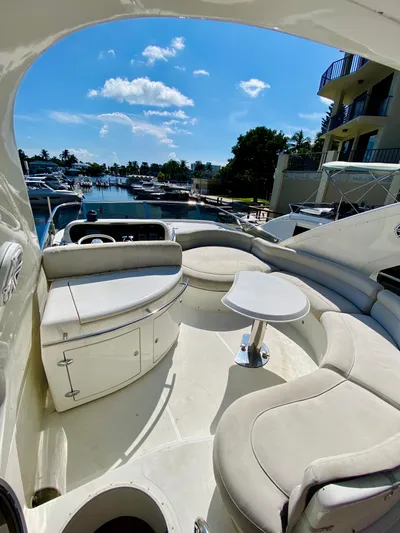 Last Minute Yacht Photos Pics Luxurious 2002 Azimut 55 yacht interior with plush seating and scenic marina view.