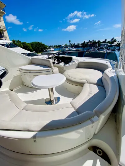 Last Minute Yacht Photos Pics Luxurious 2002 Azimut 55 yacht with elegant seating area and table.