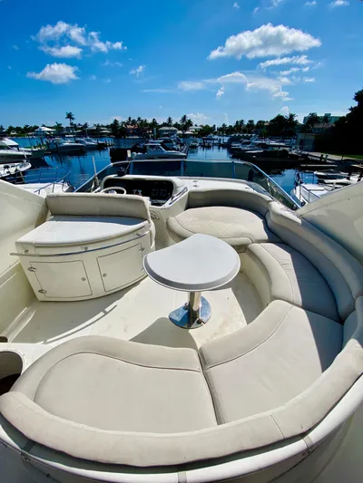 Last Minute Yacht Photos Pics Luxurious 2002 Azimut 55 yacht with spacious seating and scenic marina view.