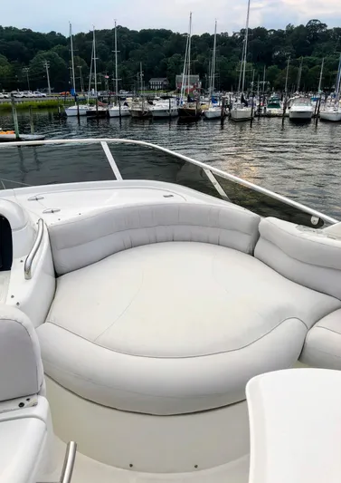 Last Minute Yacht Photos Pics 2002 Azimut 55 yacht with spacious white seating, docked in a marina.