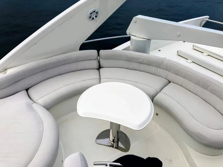 Last Minute Yacht Photos Pics Luxurious seating area on 2002 Azimut 55 yacht, featuring elegant white upholstery.