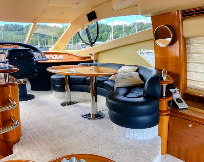 Last Minute Yacht Photos Pics Luxurious interior of a 2002 Azimut 55 yacht with elegant seating and wooden accents.