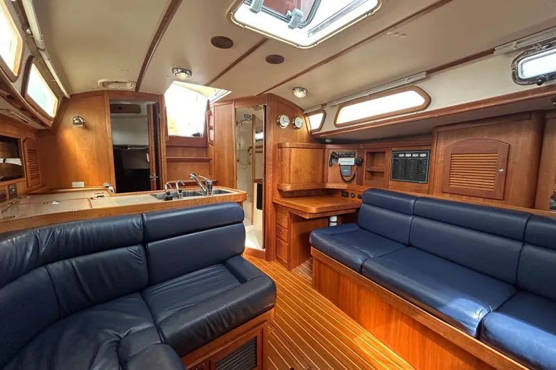Indigo Yacht Photos Pics Interior of 2002 Sabre 362 yacht with wooden finish and blue seating.