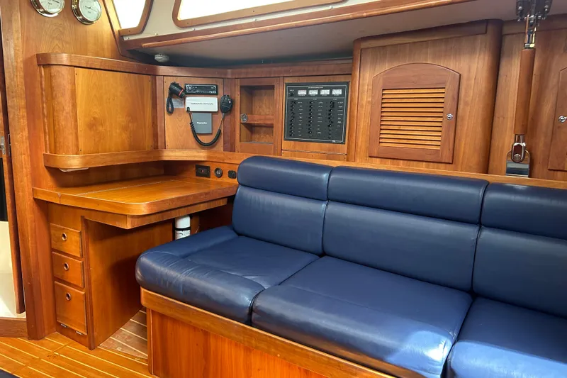Indigo Yacht Photos Pics Interior of 2002 Sabre 362 yacht with wooden cabinetry and blue leather seating.