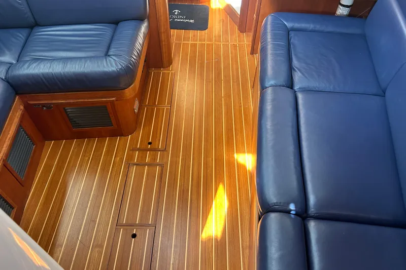 Indigo Yacht Photos Pics Interior of 2002 Sabre 362 yacht with blue leather seating and wooden flooring.