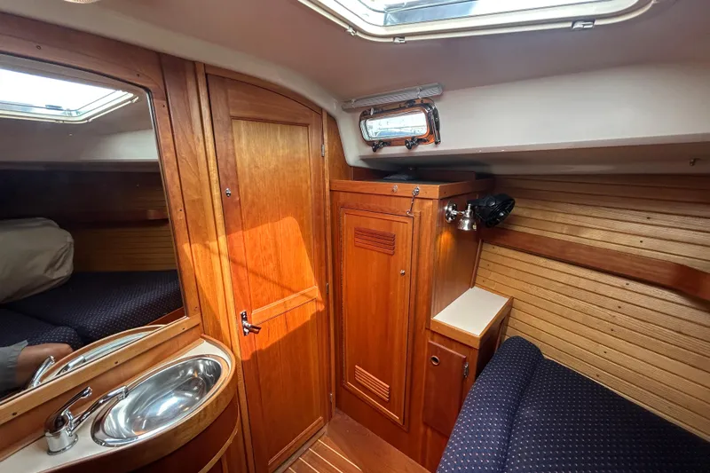 Indigo Yacht Photos Pics 2002 Sabre 362 yacht interior with wooden cabinetry and compact sink.