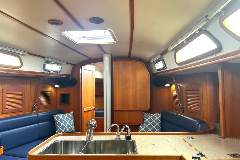 Indigo Yacht Photos Pics Interior of 2002 Sabre 362 sailboat with wood finish and blue seating.