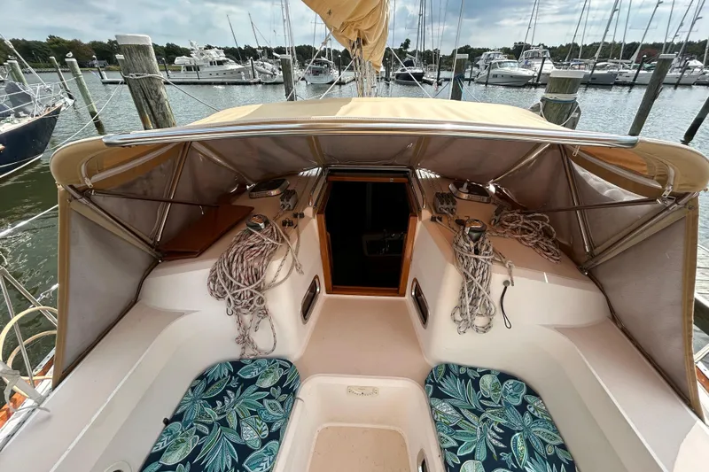 Indigo Yacht Photos Pics 2002 Sabre 362 sailboat cockpit with canopy, ropes, and patterned cushions at marina.