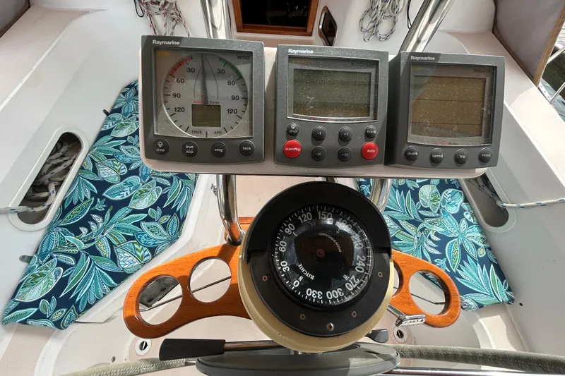 Indigo Yacht Photos Pics Cockpit of 2002 Sabre 362 sailboat with navigation instruments and floral cushions.