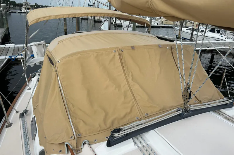 Indigo Yacht Photos Pics 2002 Sabre 362 sailboat with tan canvas cover docked at marina.