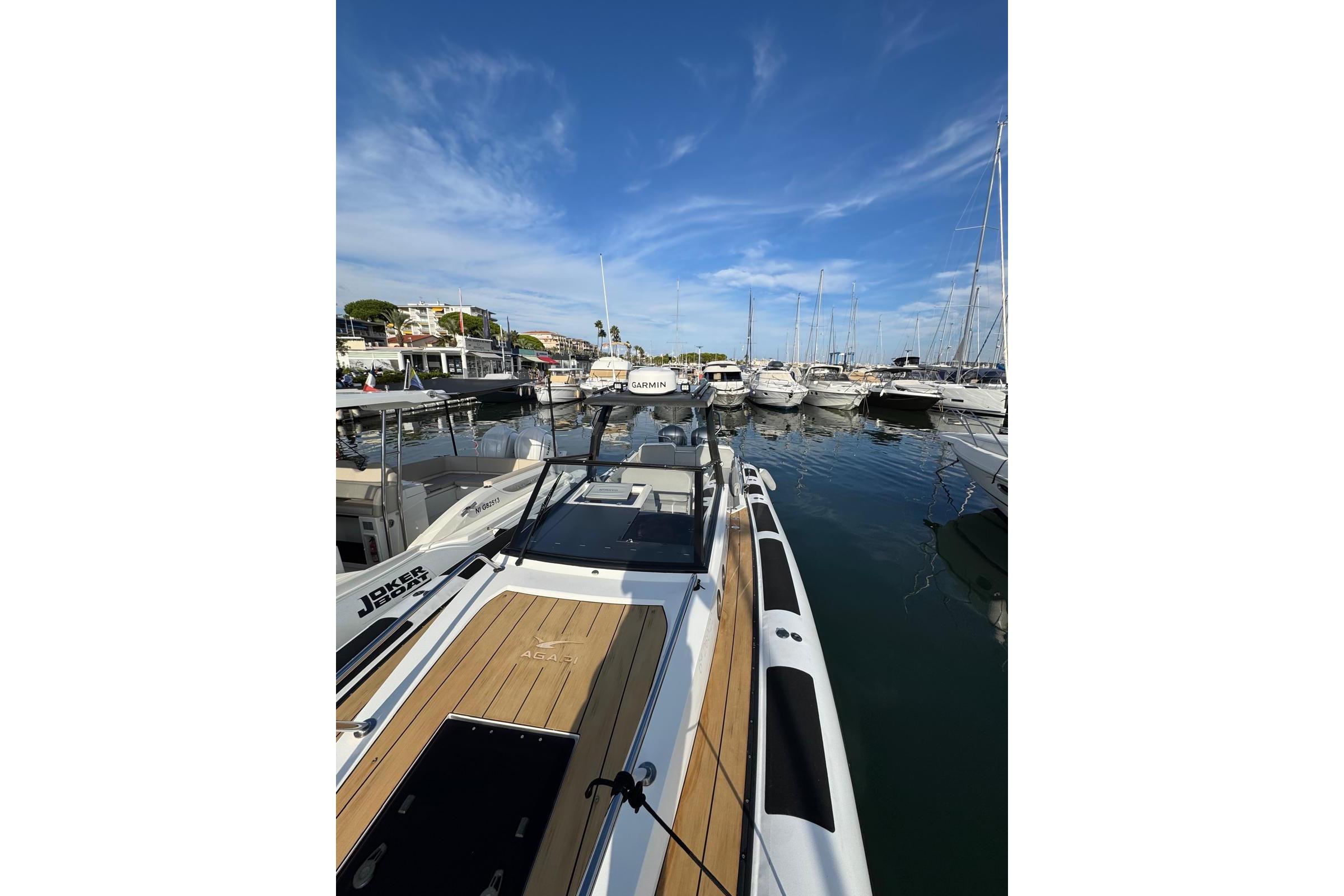 2019 Agapi 950 boat docked in a marina under a clear blue sky.