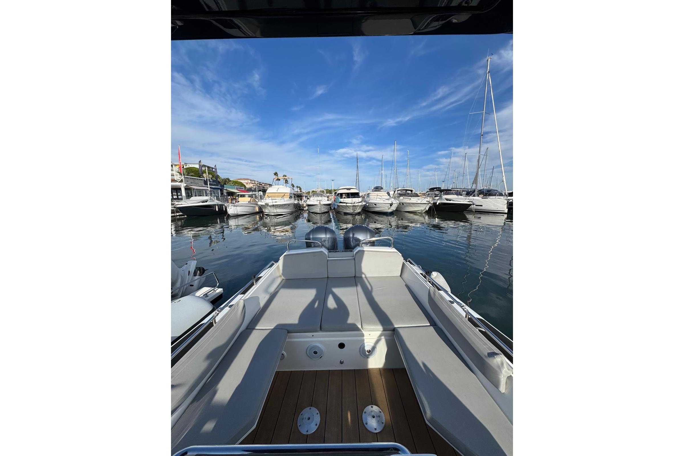 Agapi 950 boat, 2019 model, docked in marina with clear blue sky.