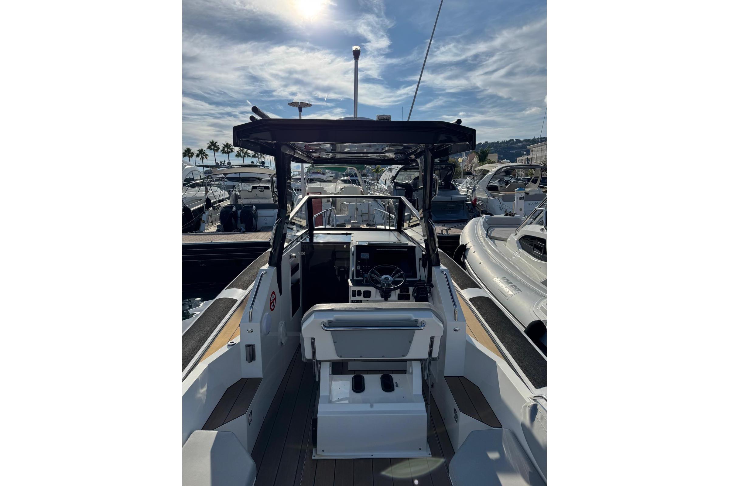 2019 Agapi 950 boat interior with steering wheel, docked under a sunny sky.