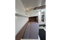 Interior cabin of 2019 Agapi 950 boat, featuring cozy seating and modern design.