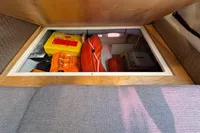 Storage compartment in 2019 Agapi 950 boat with safety equipment and supplies.
