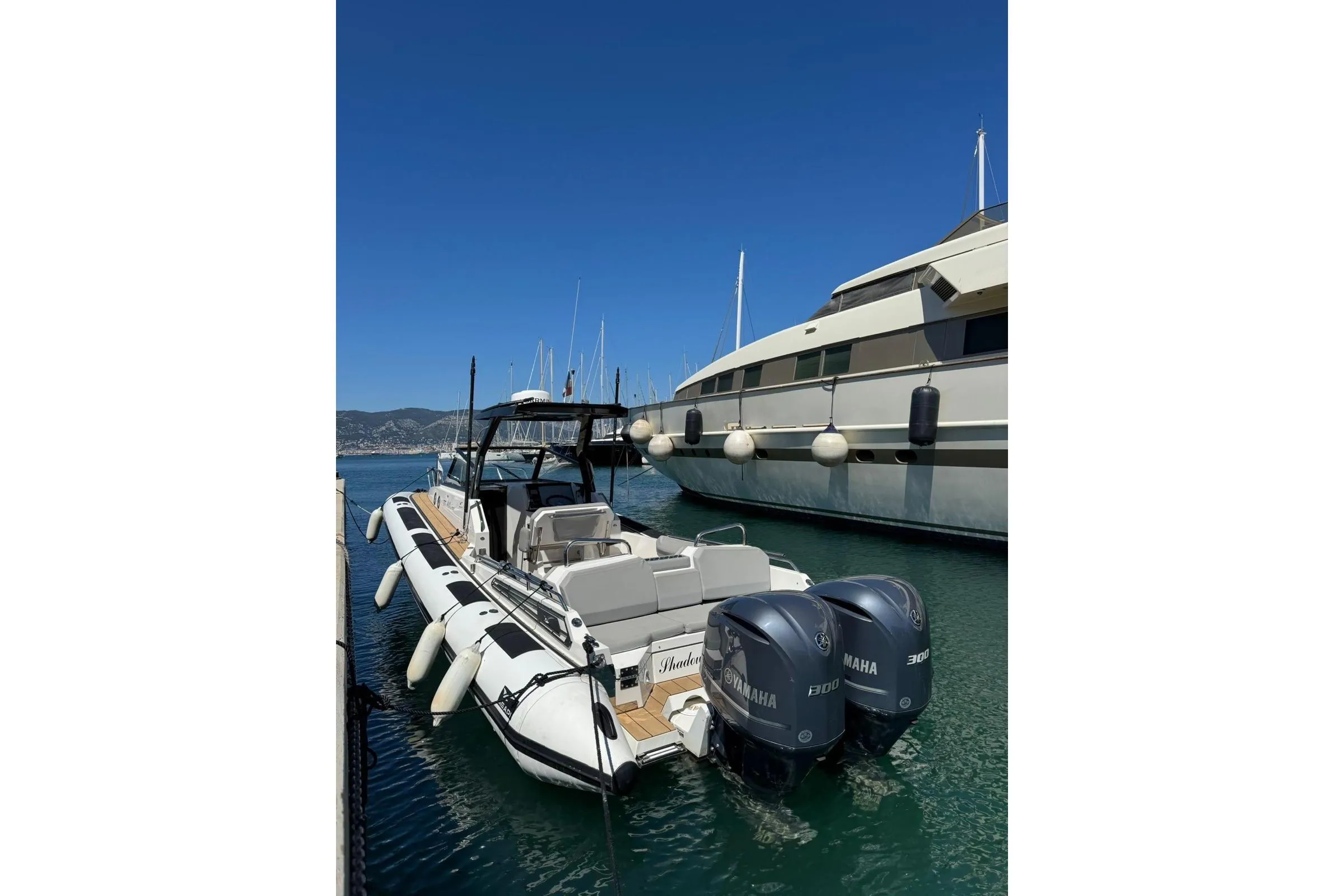 2019 Agapi 950 boat with dual Yamaha engines docked in a marina.