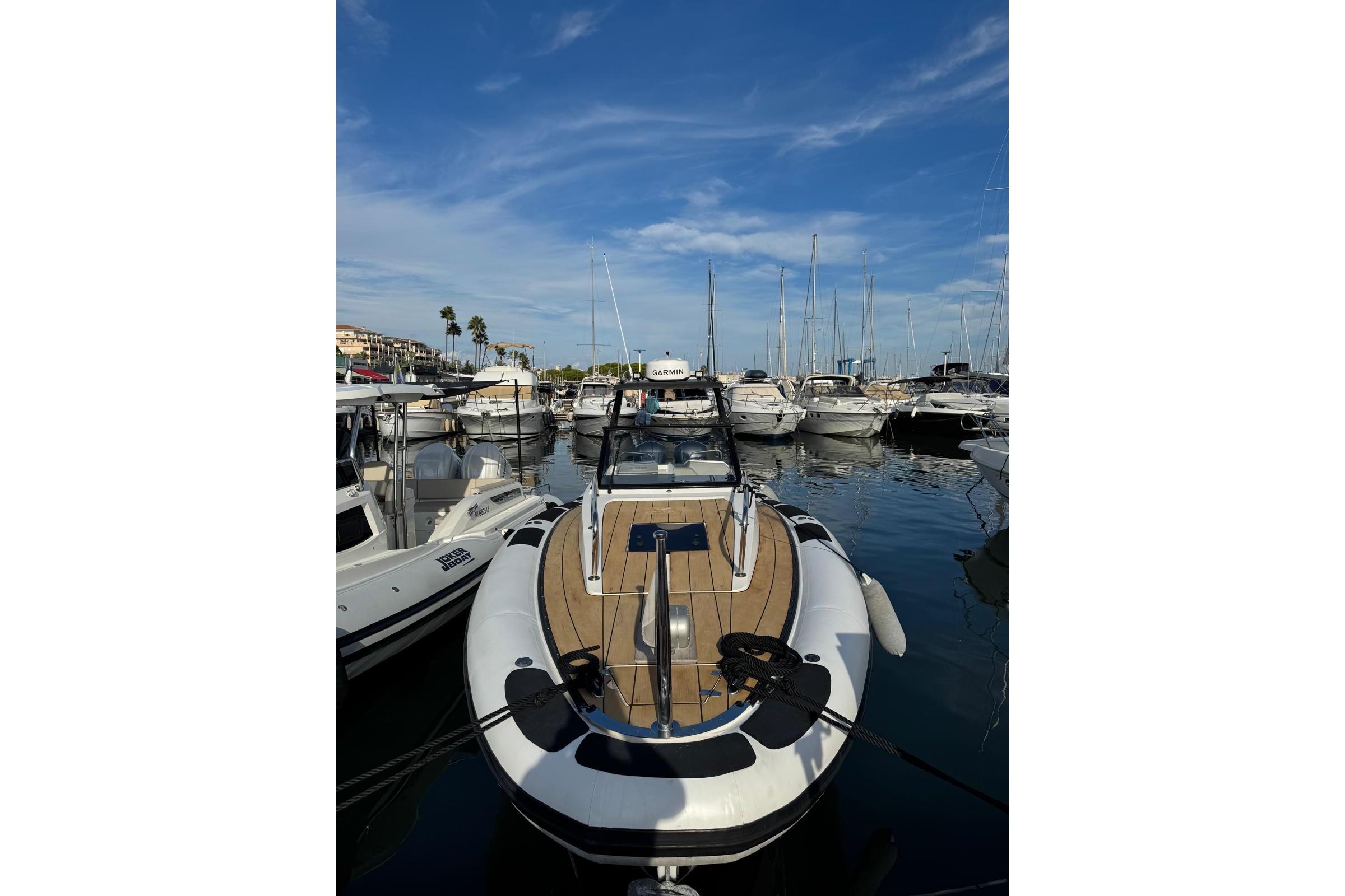 2019 Agapi 950 boat docked in a marina under a clear blue sky.