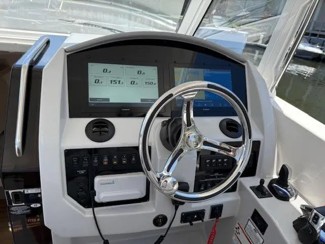  Yacht Photos Pics 2023 Regal 33 SAV boat dashboard with steering wheel and digital displays.
