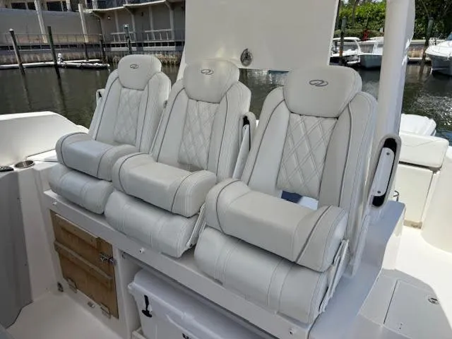  Yacht Photos Pics 2023 Regal 33 SAV boat with luxurious white seating in a marina setting.