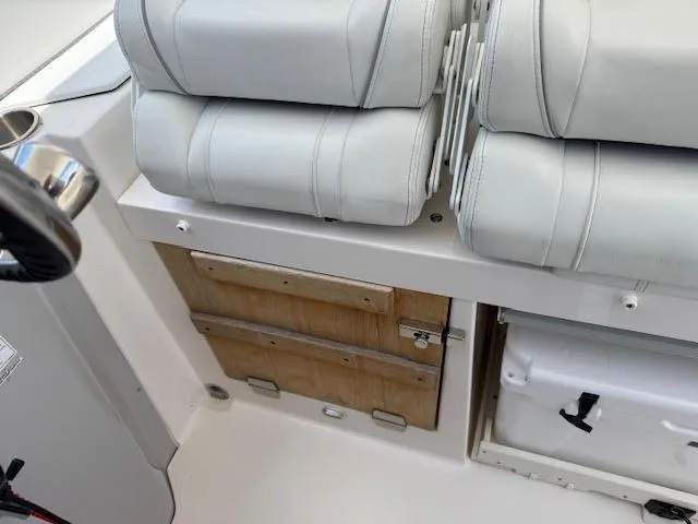  Yacht Photos Pics Interior of 2023 Regal 33 SAV boat with white seating and storage compartments.