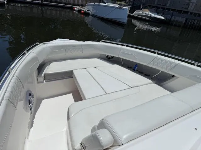  Yacht Photos Pics 2023 Regal 33 SAV boat with spacious white seating area docked by the water.