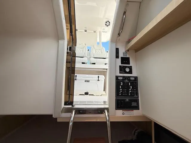  Yacht Photos Pics 2023 Regal 33 SAV boat interior with control panel and ladder access.