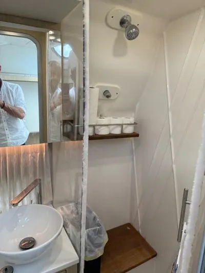  Yacht Photos Pics 2023 Regal 33 SAV bathroom with modern sink, shower, and wooden accents.