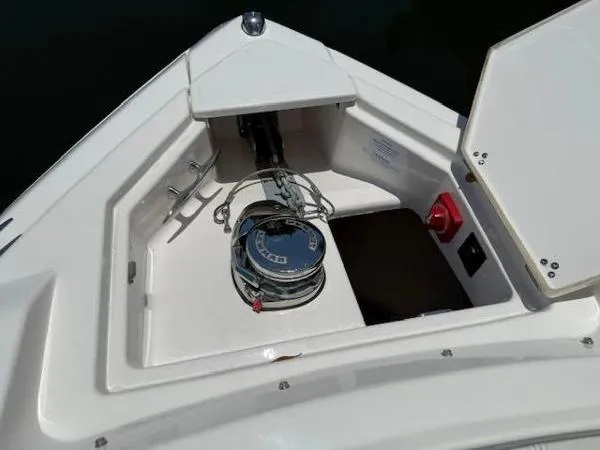  Yacht Photos Pics Anchor compartment of 2023 Regal 33 SAV boat, featuring a neatly coiled rope and anchor system.