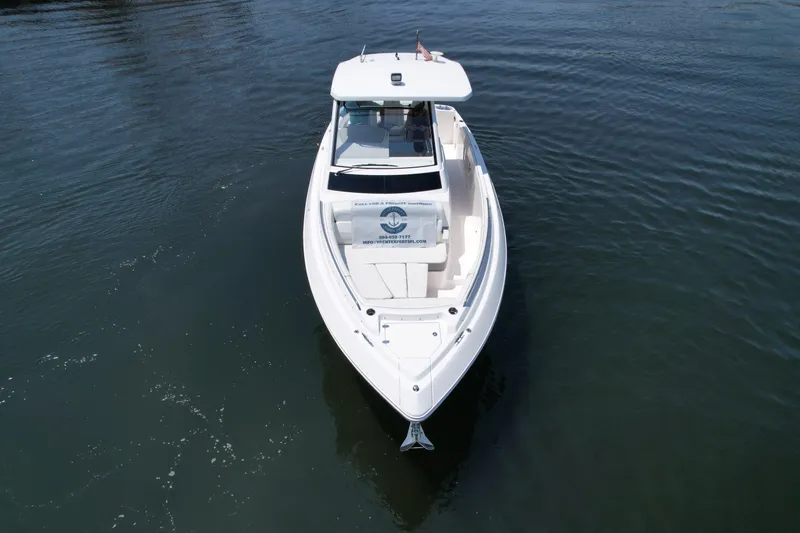  Yacht Photos Pics 2023 Regal 33 SAV boat on calm water, aerial view.