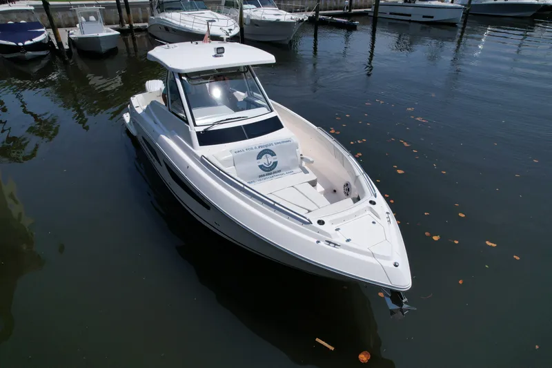  Yacht Photos Pics 2023 Regal 33 SAV boat docked in marina, sleek design, calm water.