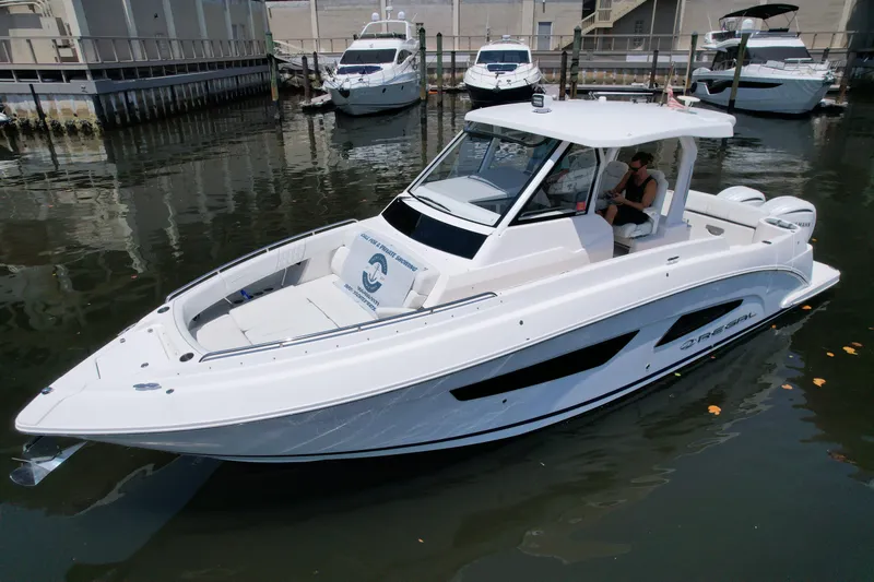  Yacht Photos Pics 2023 Regal 33 SAV boat docked in marina, sleek design, white exterior.