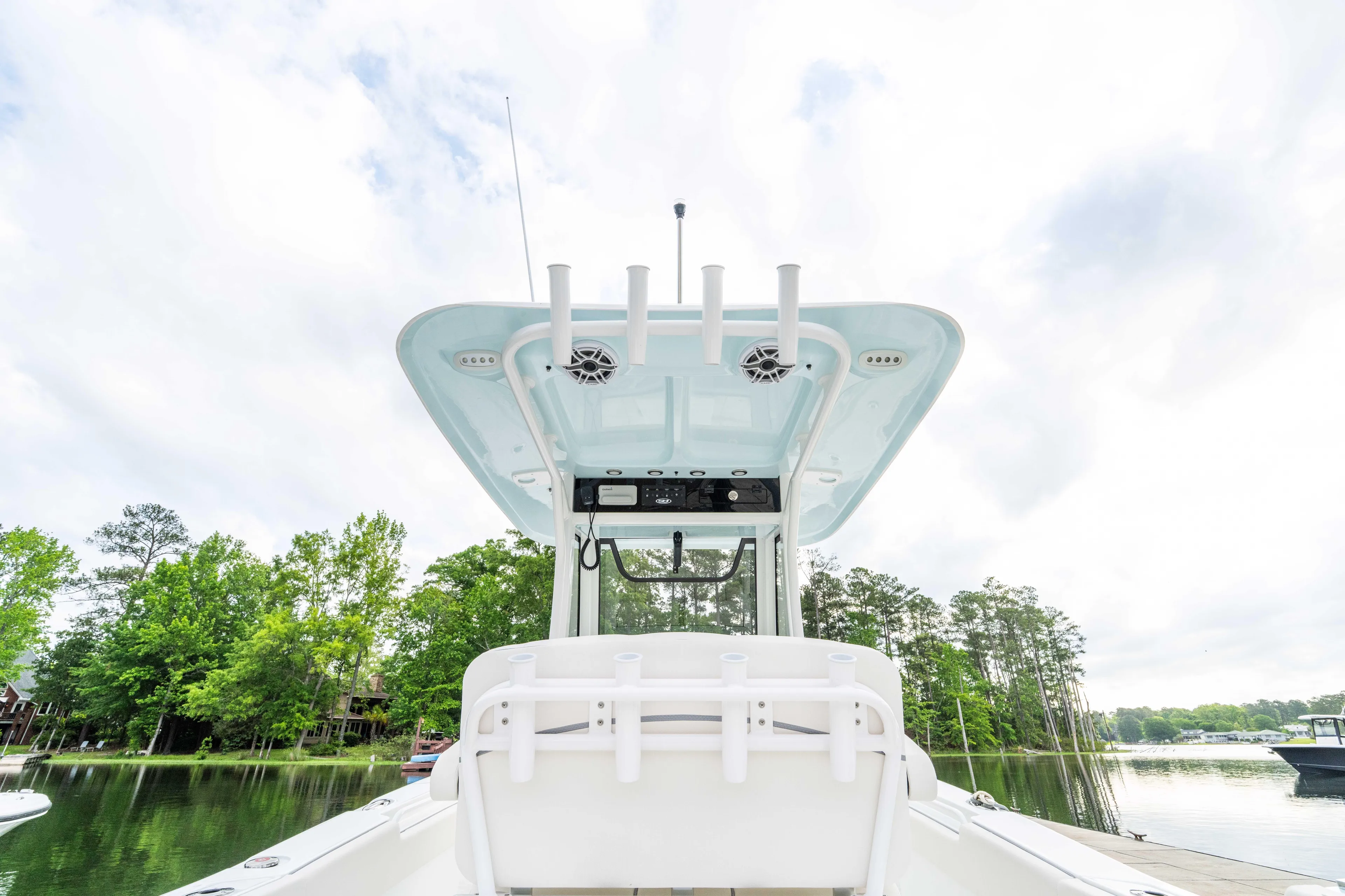  Yacht Photos Pics 2026 Sea Hunt Gamefish 27 boat with forward seating, docked on a serene lake.