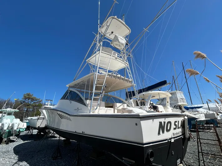 No Slack Yacht Photos Pics 2002 Albemarle 410 Express Fisherman boat with tower, docked under clear blue sky.