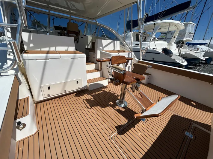 No Slack Yacht Photos Pics 2002 Albemarle 410 Express Fisherman boat deck with fishing chair and teak flooring.