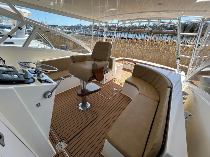 No Slack Yacht Photos Pics 2002 Albemarle 410 Express Fisherman boat interior with helm and seating area.