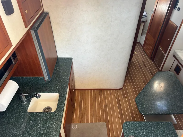 No Slack Yacht Photos Pics Interior of 2002 Albemarle 410 Express Fisherman with kitchenette and wood flooring.
