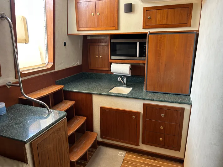 No Slack Yacht Photos Pics 2002 Albemarle 410 Express Fisherman interior kitchen with wooden cabinets and modern appliances.