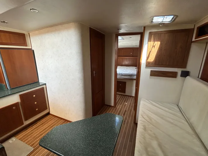 No Slack Yacht Photos Pics Interior of 2002 Albemarle 410 Express Fisherman, featuring wood cabinetry and seating area.