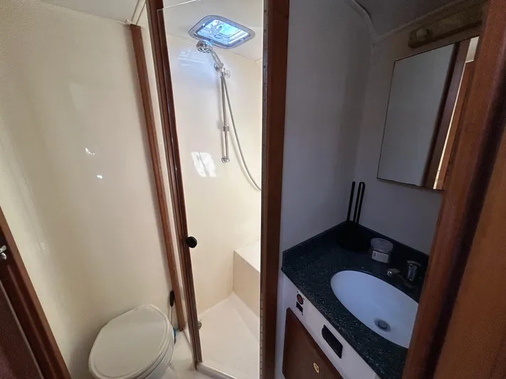 No Slack Yacht Photos Pics 2002 Albemarle 410 Express Fisherman bathroom with shower, toilet, and sink.